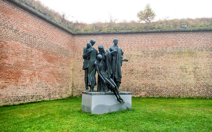 Statue of figures in Terezin Concentration Camp courtyard.