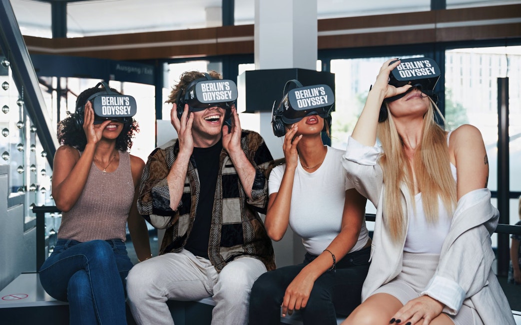 Visitors enjoying Berlin's Odyssey virtual reality experience, exploring 9 centuries of history.