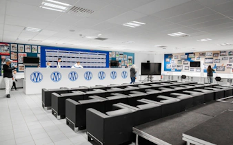 Press room at CEPAC Vélodrome during OM guided tour, featuring seating and display wall.