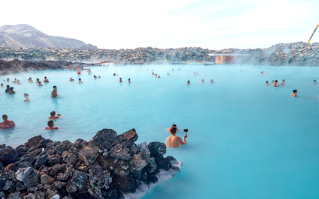 Tourists relaxing in the Blue Lagoon's geothermal waters in Iceland.