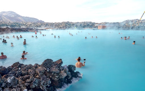 Tourists relaxing in the Blue Lagoon's geothermal waters in Iceland.