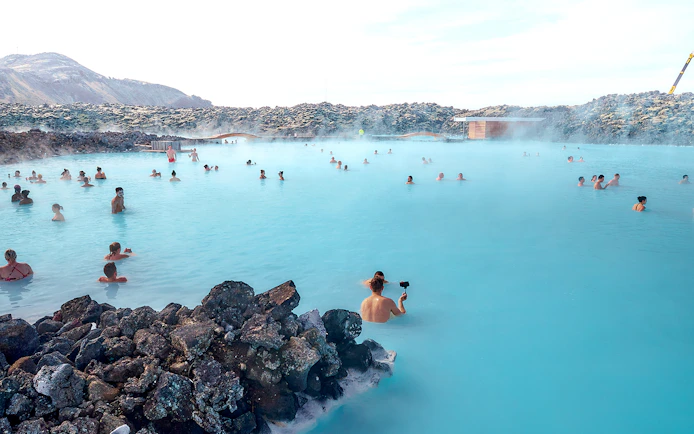 Tourists relaxing in the Blue Lagoon's geothermal waters in Iceland.