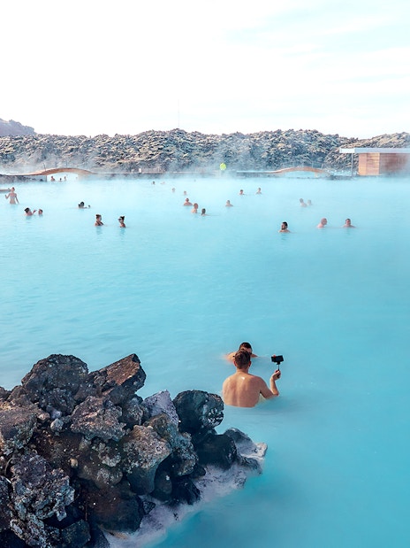 Tourists relaxing in the Blue Lagoon's geothermal waters in Iceland.