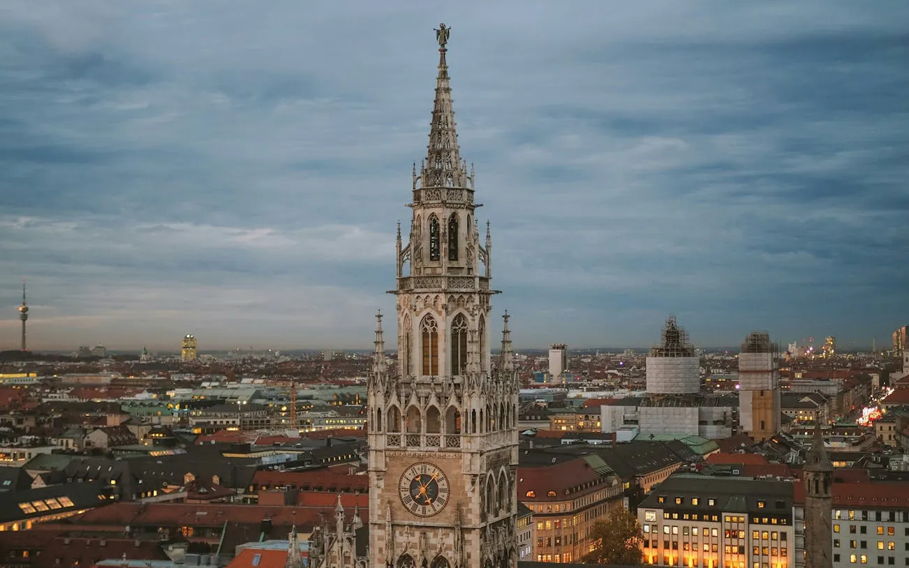 Munich cityscape with New Town Hall tower at dusk.