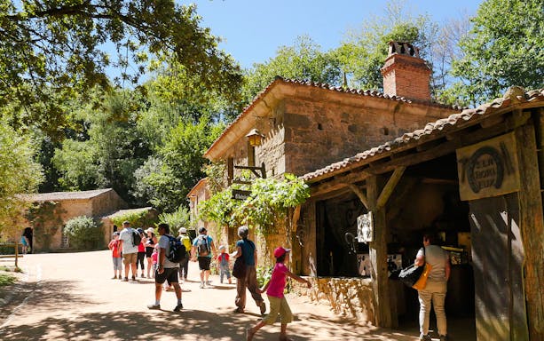 Visitors exploring historic village at Puy Du Fou, France.
