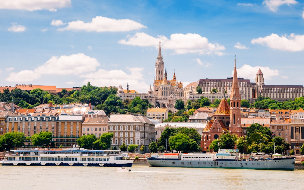 Danube River cruise passing Fisherman's Bastion and Matthias Church in Budapest.
