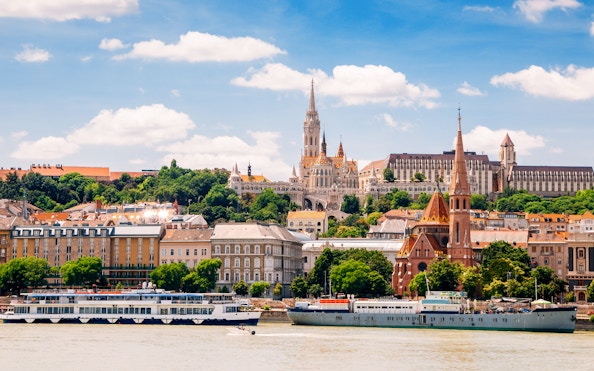 Danube River cruise passing Fisherman's Bastion and Matthias Church in Budapest.