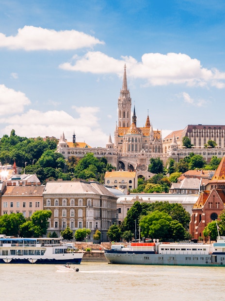 Danube River cruise passing Fisherman's Bastion and Matthias Church in Budapest.