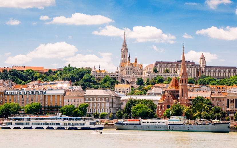 Danube River cruise passing Fisherman's Bastion and Matthias Church in Budapest.