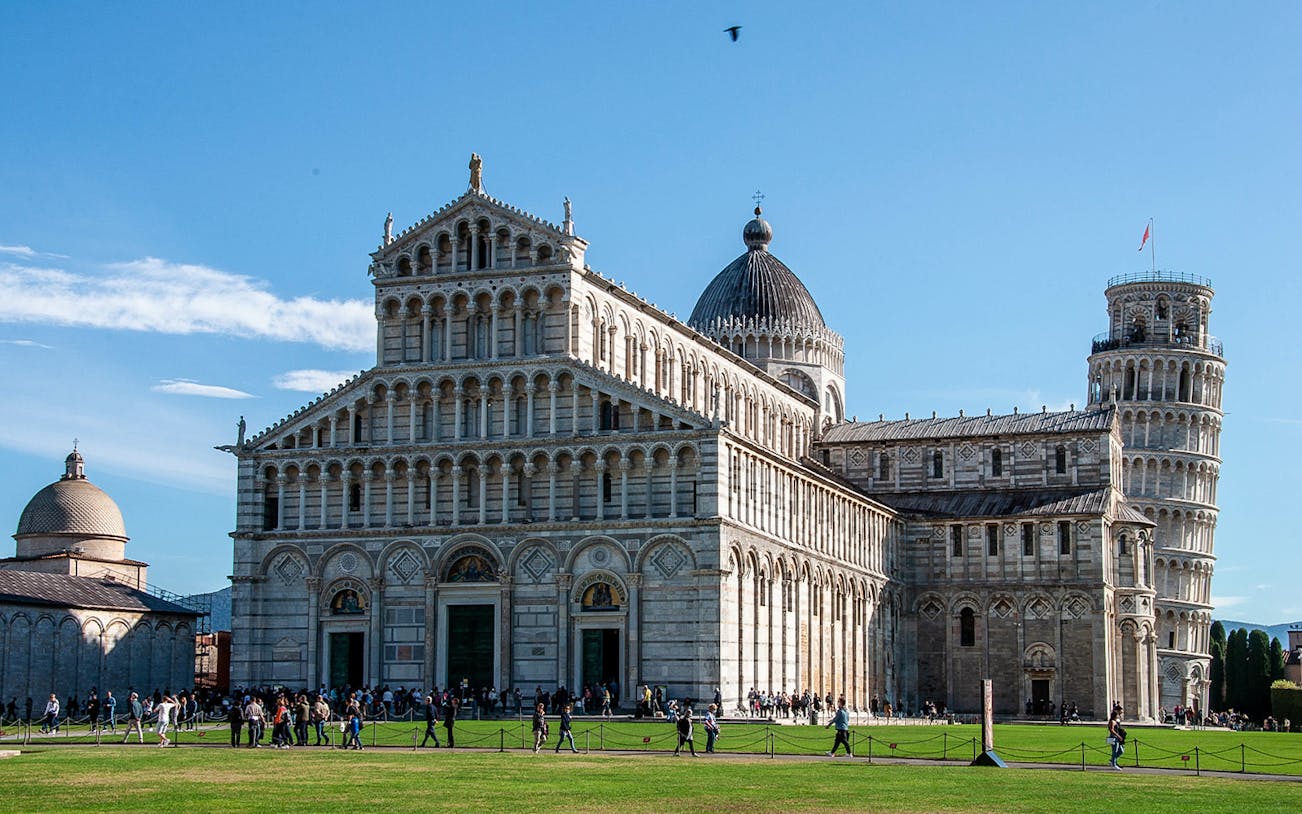 Pisa Cathedral and Leaning Tower with tourists on a guided tour.