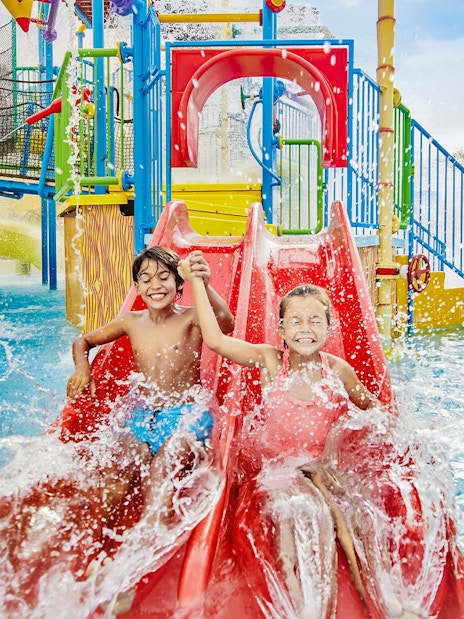 Children on a red water slide at Caribe Aquatic Park.