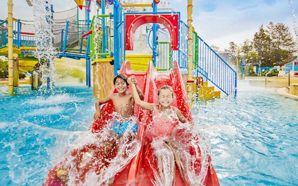 Children on a red water slide at Caribe Aquatic Park.