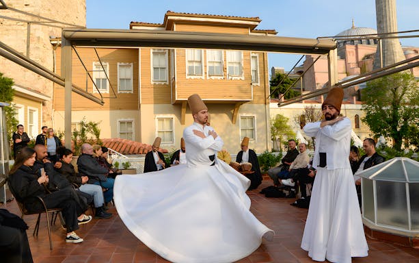 Whirling dervishes performing with Hagia Sophia in the background, Istanbul.