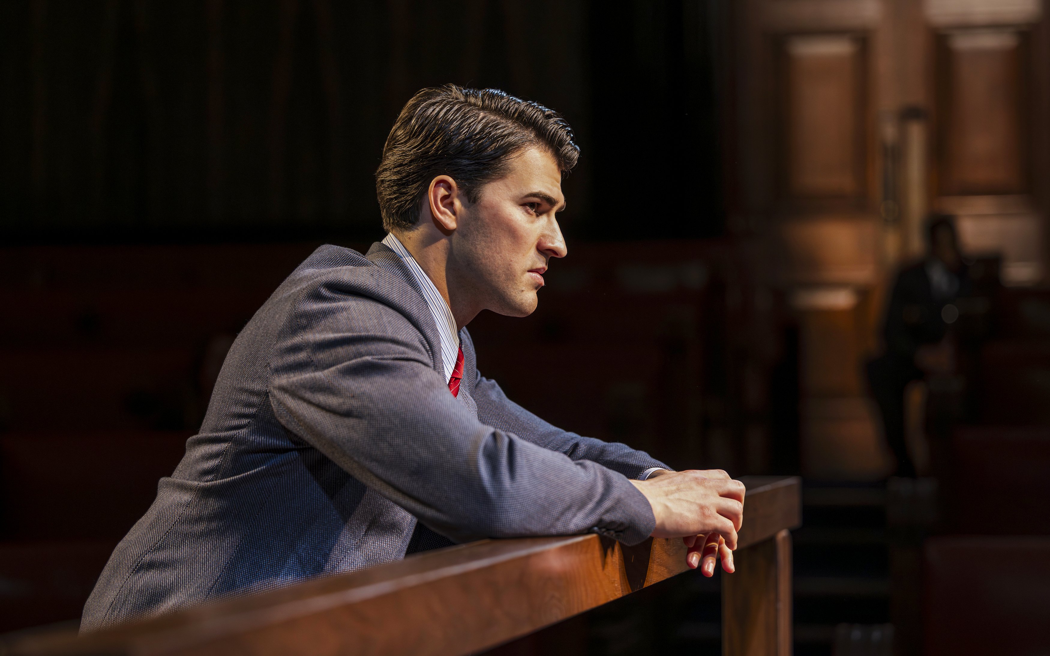 Cast member in courtroom attire during "Witness for the Prosecution" West End show.