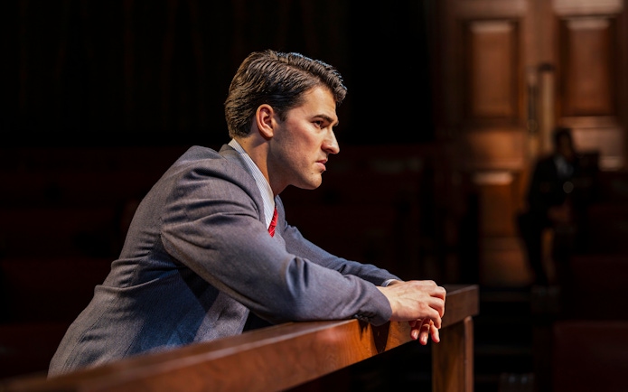 Cast member in courtroom attire during "Witness for the Prosecution" West End show.