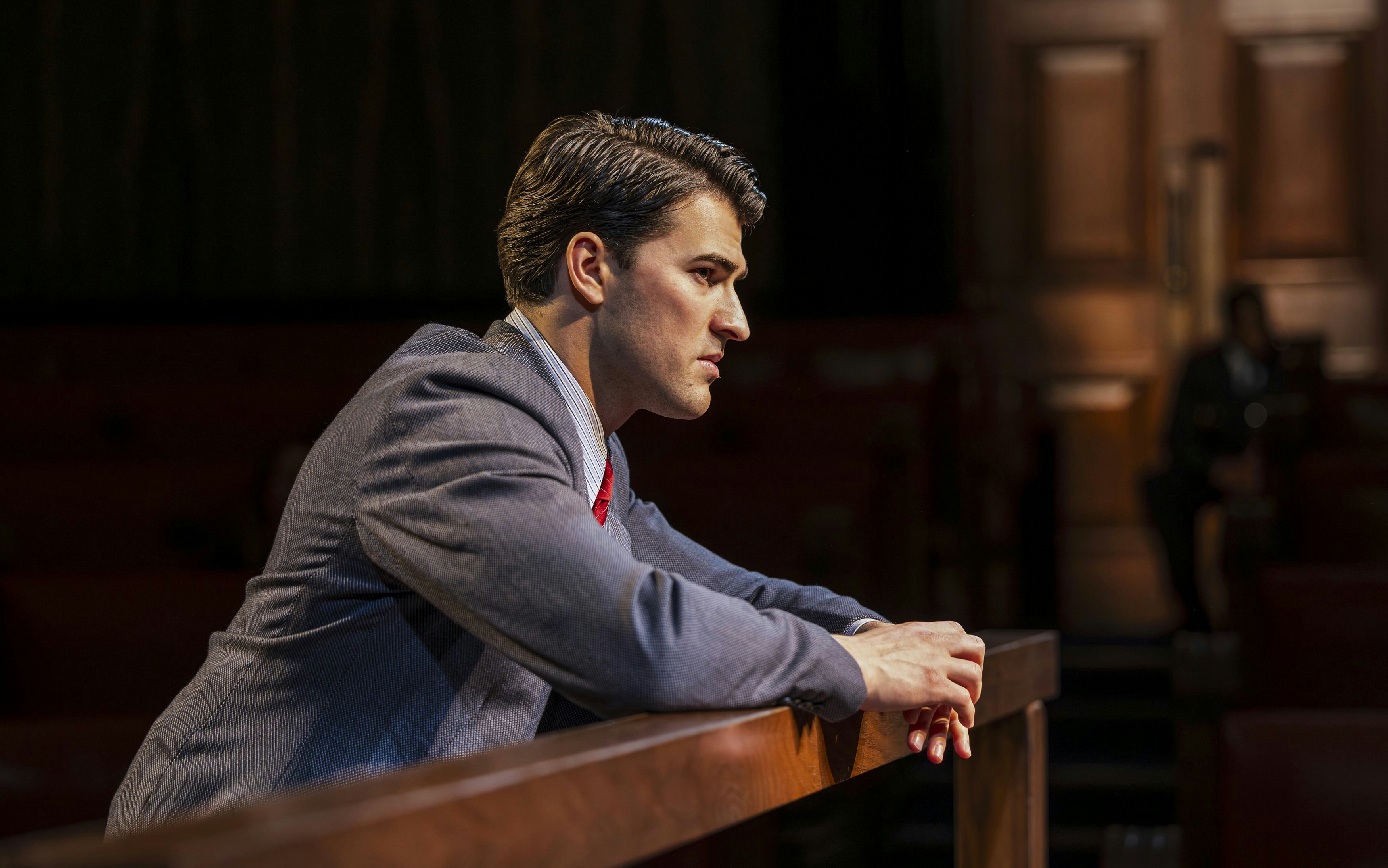 Cast member in courtroom attire during "Witness for the Prosecution" West End show.