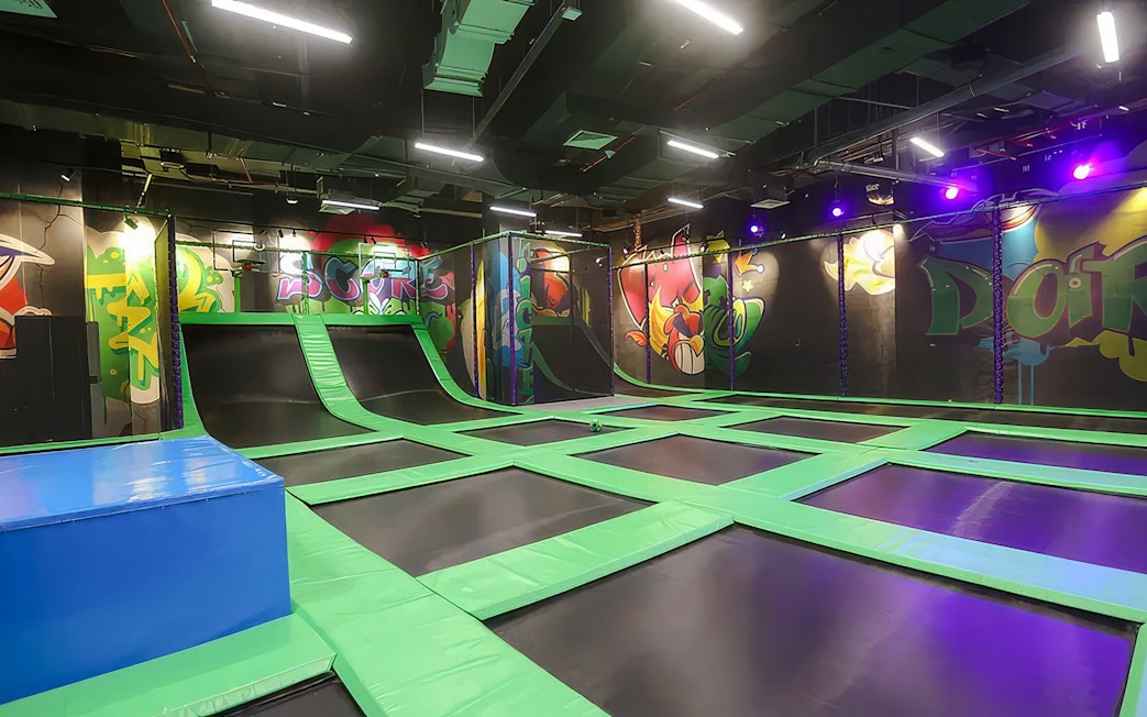 Indoor trampoline area at Angry Birds World Theme Park with colorful graffiti walls.