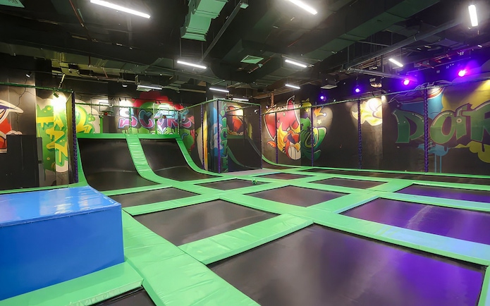 Indoor trampoline area at Angry Birds World Theme Park with colorful graffiti walls.