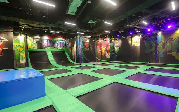 Indoor trampoline area at Angry Birds World Theme Park with colorful graffiti walls.