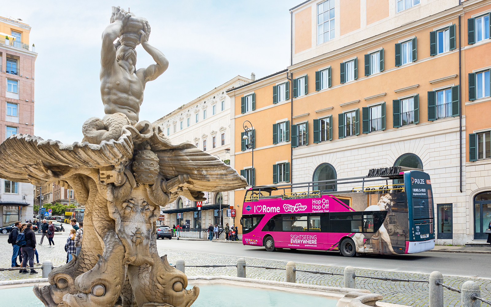 Triton Fountain with I Love Rome hop-on hop-off tour bus in Rome, Italy.