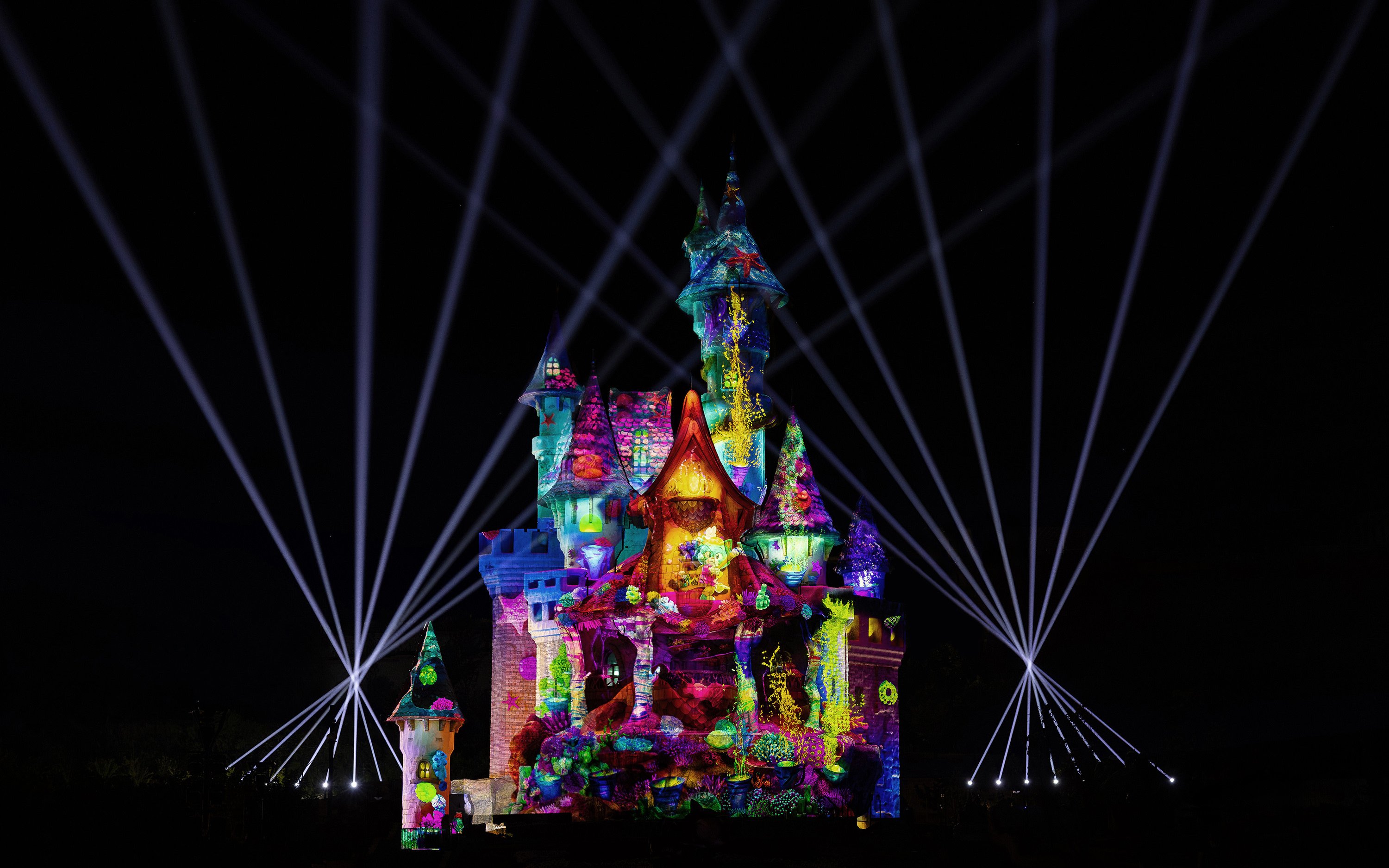 Light show illuminating castle at Lotte World Adventure Busan.