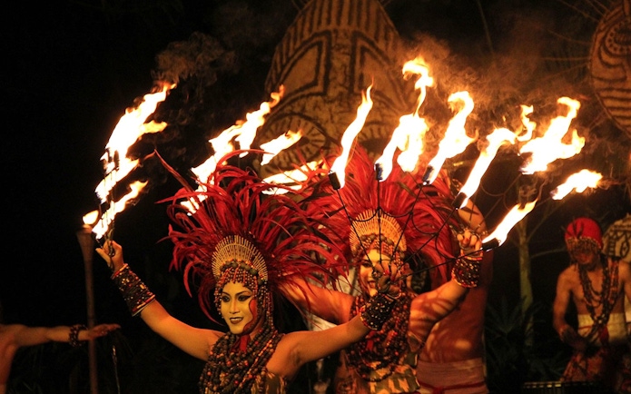 Fire dancers performing at Bali Safari with traditional costumes and flaming torches.