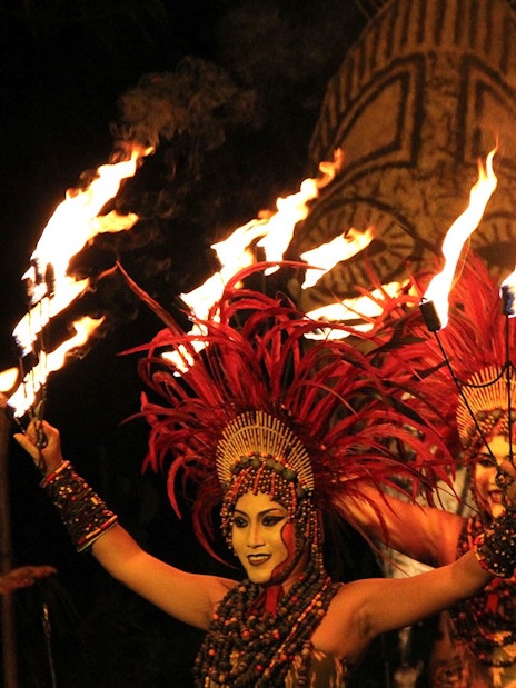 Fire dancers performing at Bali Safari with traditional costumes and flaming torches.