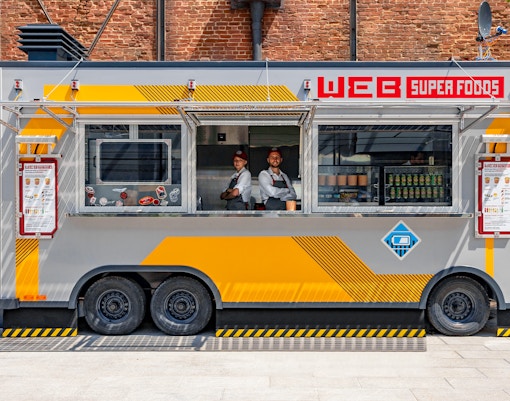 WEB Food Truck at Disneyland Paris with staff inside serving visitors.