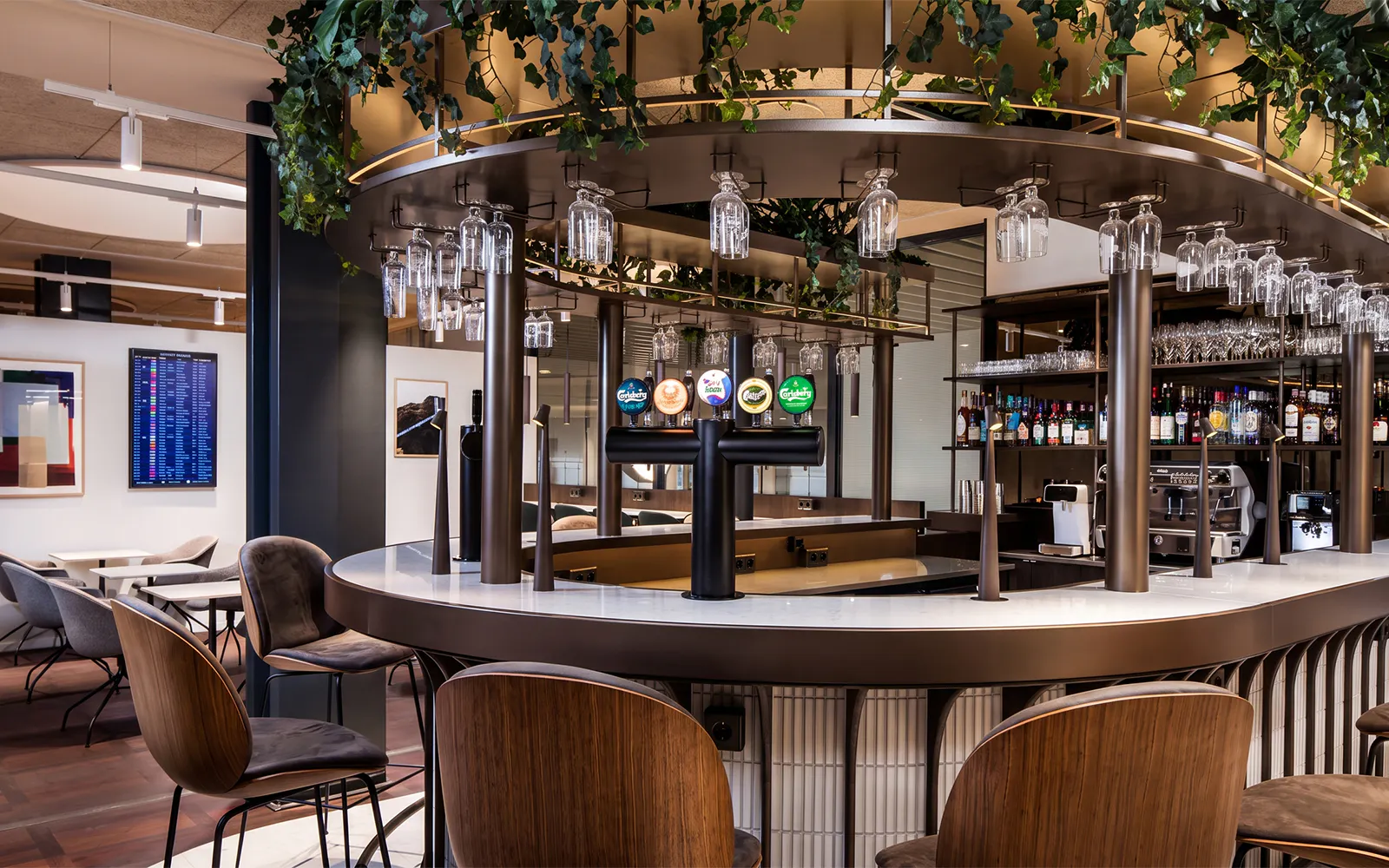 Bar area in Aspire Lounge at Copenhagen Kastrup Airport Terminal 2 with seating and drink options.