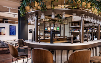 Bar area in Aspire Lounge at Copenhagen Kastrup Airport Terminal 2 with seating and drink options.