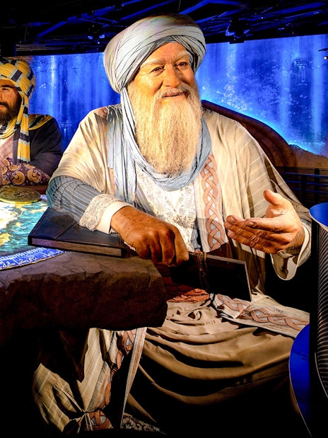 Historical figures discussing a map at Expo City Dubai exhibit.