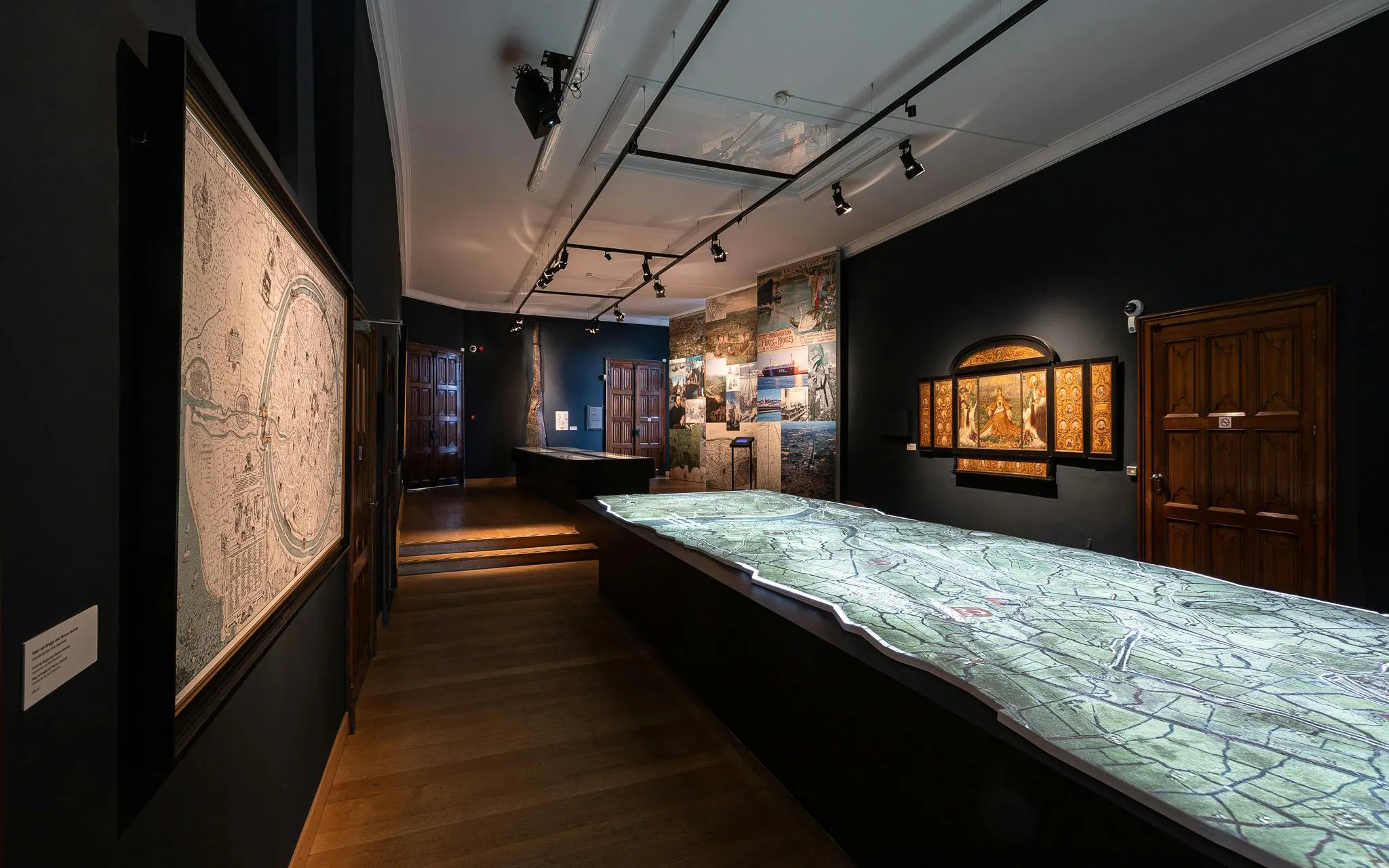 Exhibit room with historical maps and artwork at Bruges City Hall.