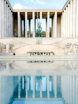 Tokyo Palace in Paris with statue and reflecting pool.