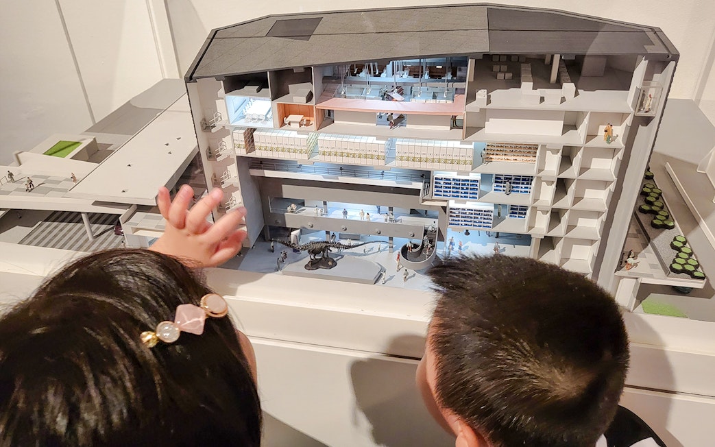 Children observing a model of Lee Kong Chian Natural History Museum, Singapore.