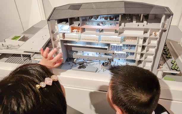 Children observing a model of Lee Kong Chian Natural History Museum, Singapore.
