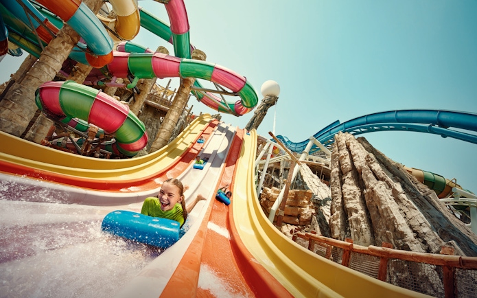 Girl sliding on Sebag water slide at YAS Waterworld, Abu Dhabi.