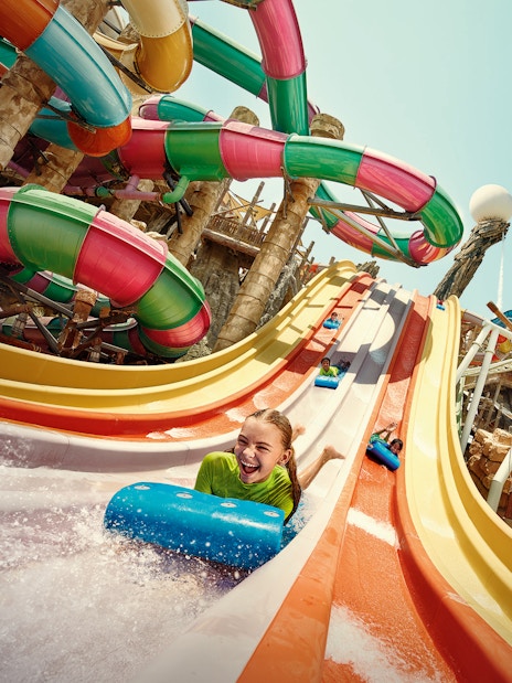 Girl sliding on Sebag water slide at YAS Waterworld, Abu Dhabi.