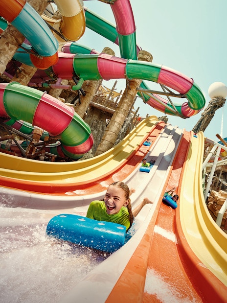Girl sliding on Sebag water slide at YAS Waterworld, Abu Dhabi.