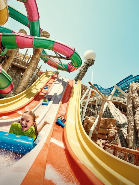 Girl sliding on Sebag water slide at YAS Waterworld, Abu Dhabi.