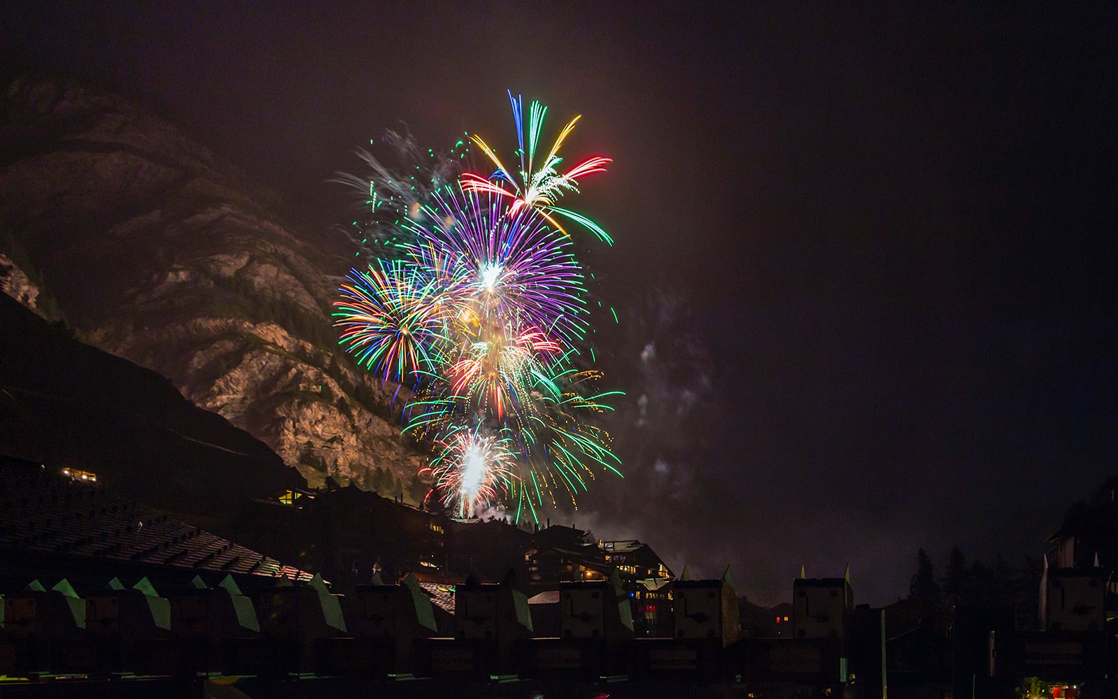 Fireworks display over Zermatt village during New Year's Eve celebration.
