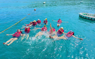 Group enjoying water activities in Nha Trang during Robinson Beach island-hopping tour.
