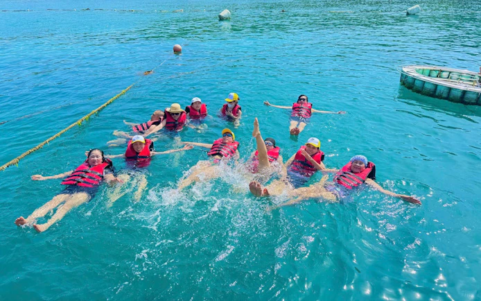 Group enjoying water activities in Nha Trang during Robinson Beach island-hopping tour.