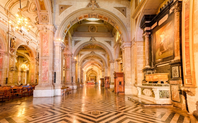 Santiago Cathedral interior with ornate arches and detailed artwork.
