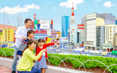 Family enjoying miniature cityscape at Legoland Japan.