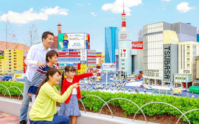 Family enjoying miniature cityscape at Legoland Japan.