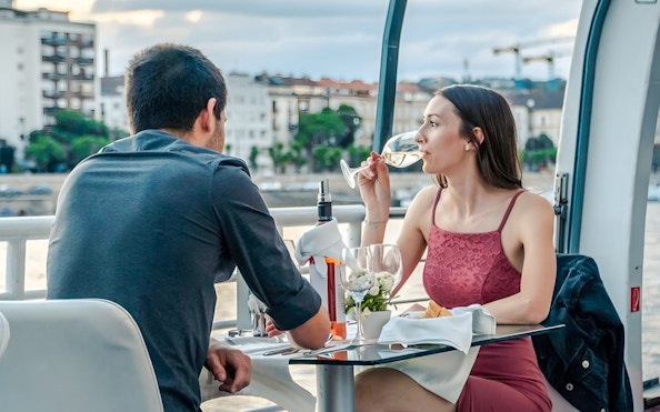Couple enjoying a candlelit dinner on a Budapest river cruise.