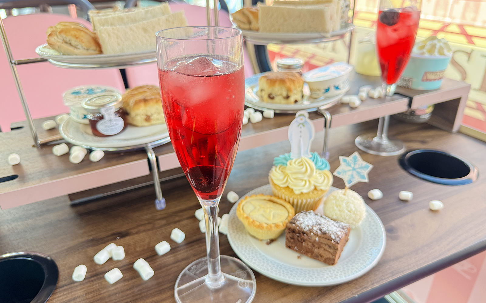 Afternoon tea treats with scones, sandwiches, and pastries on The Snowman Official Afternoon Tea Bus.