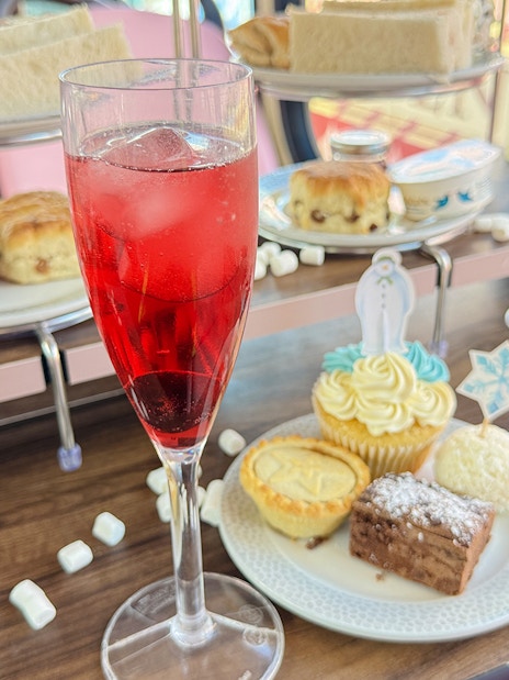 Afternoon tea treats with scones, sandwiches, and pastries on The Snowman Official Afternoon Tea Bus.