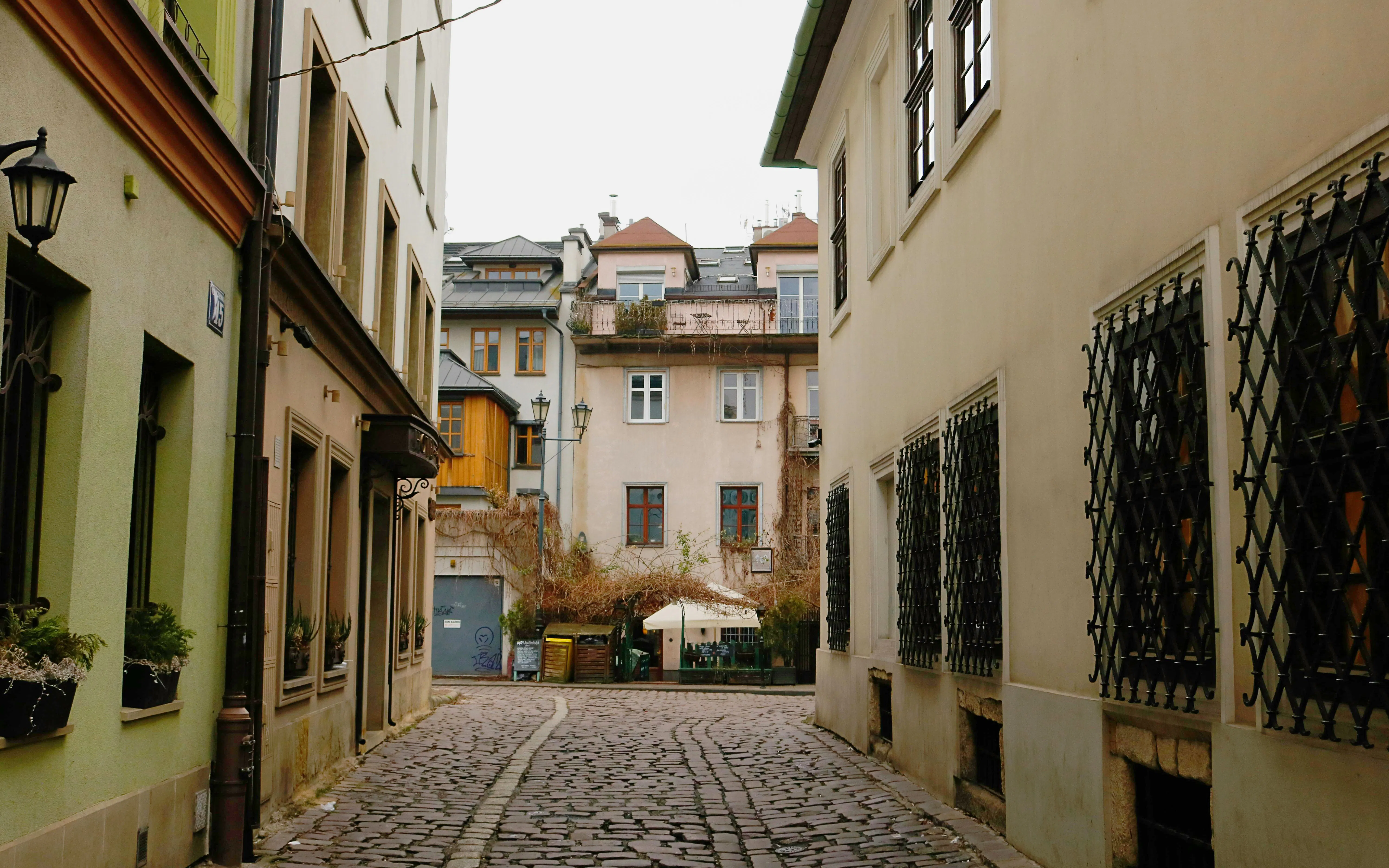 Krakow Kazimierz district cobblestone street with historic buildings on Schindler’s Story tour.
