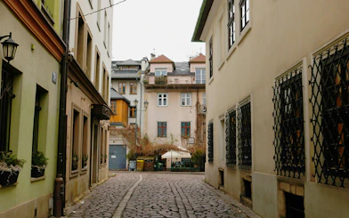 Krakow Kazimierz district cobblestone street with historic buildings on Schindler’s Story tour.